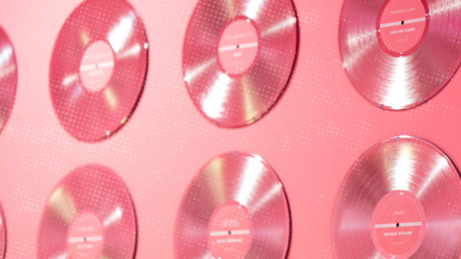 pink vinyl records lined up on a pink wall